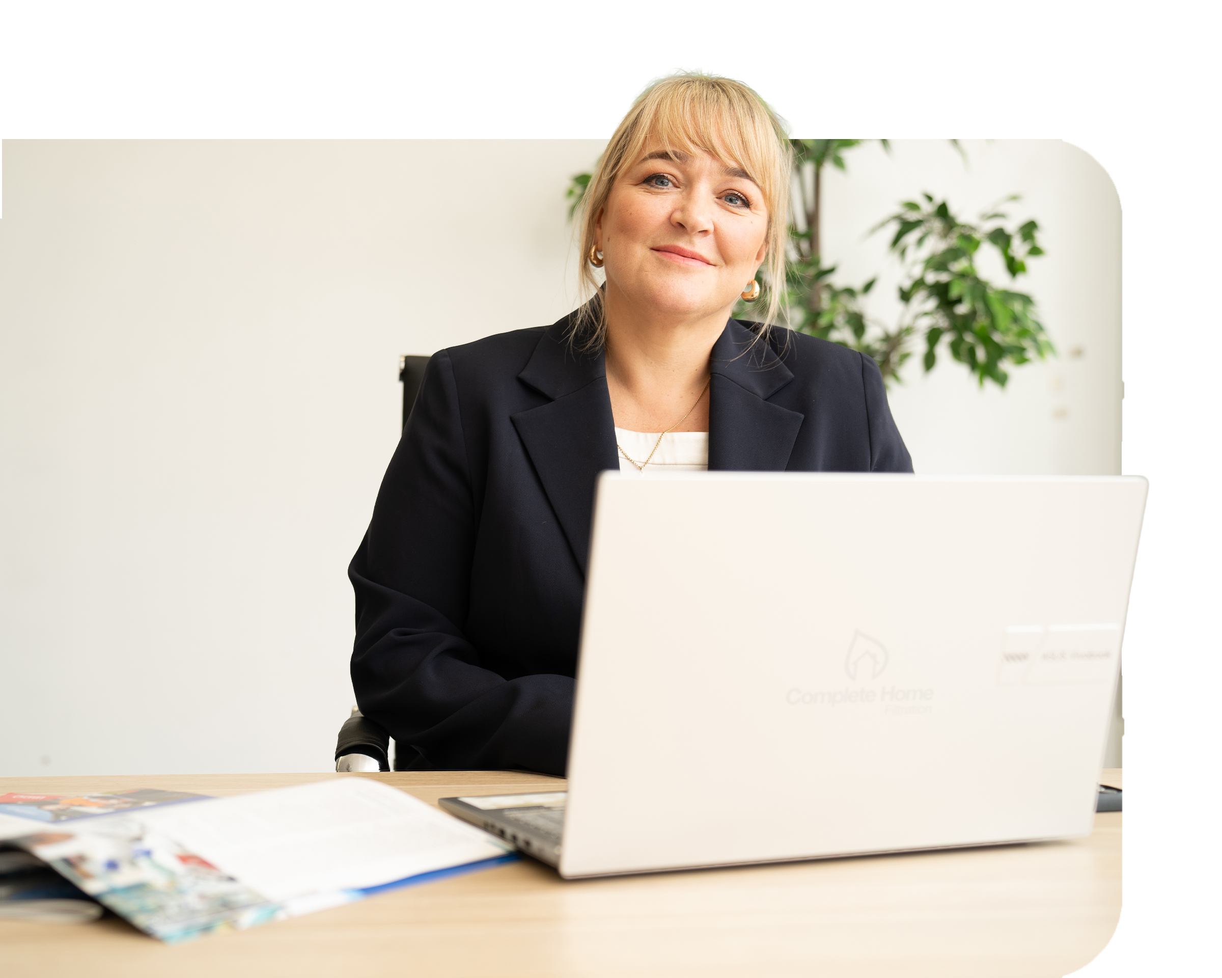 Founder Suzanne Dodds looking at camera from above a laptop screen